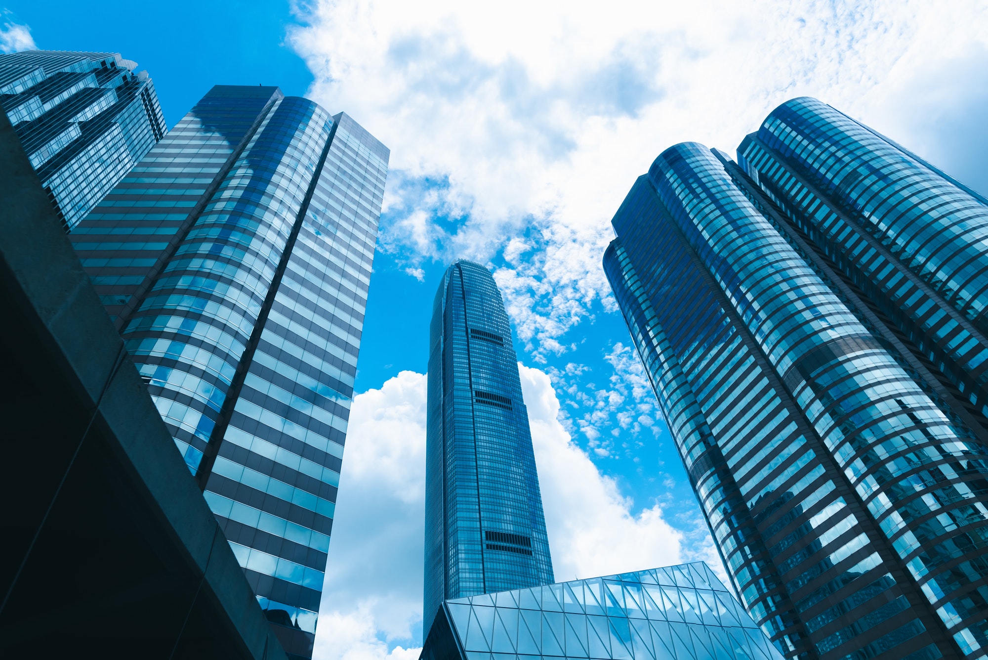 Skyscrapers rise against a bright sky, symbolizing the extensive network and collaboration of Deltona Healthcare Connection.